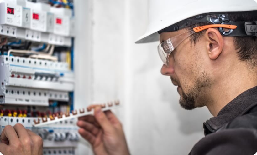 Electrical technician working on a switch